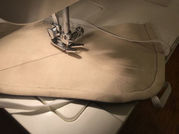 The two upper lines can be sewn in one continuous operation. When you get to the center point, make sure that the needle is down, lift up the presser foot, rotate the mask around the needle, then put the foot back down before continuing to sew.