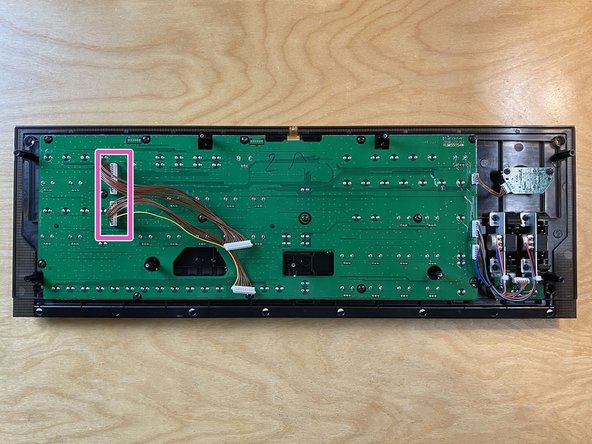Flip over the front panel so the circuit board side is facing up.