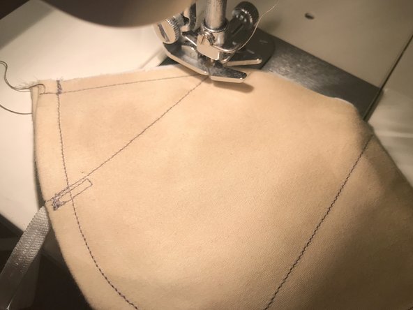 The mask should be inside-out, so that the inside of the mask is facing out and the side with the straps attached is facing in.