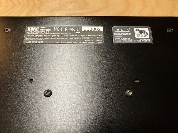 Peel off the brown and green backing paper from the serial number label.