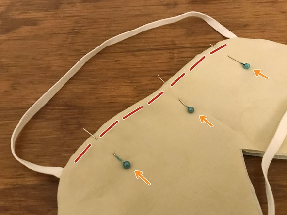 Place the prepared nose bridge insert inside the mask, between the two layers of interface material.