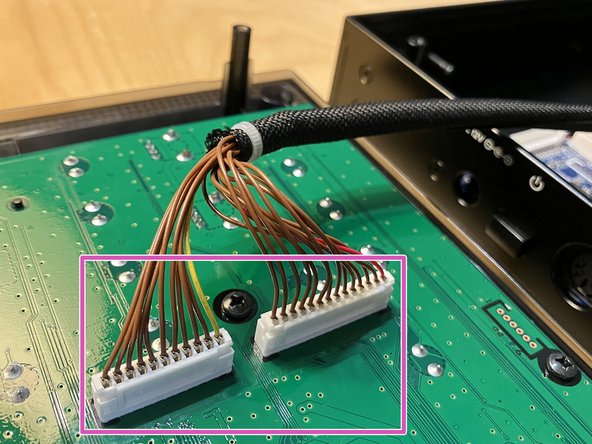 Reconnect the other end of the wrapped cables to the two white connectors on the front panel.