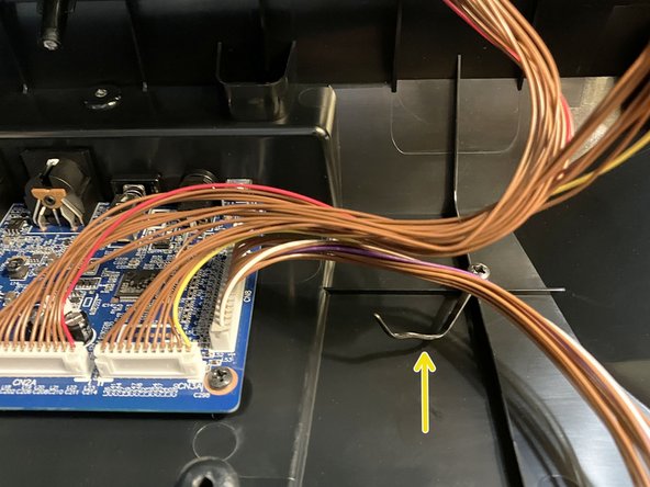 Carefully lift up the front edge of the front panel to partially reveal the internal main board and connector cables.