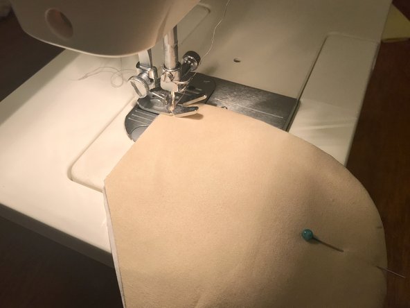 Starting from one corner, sew around the curved part of the mask, leaving a 1/4" (6 mm) gap from the edge, just like you did before.