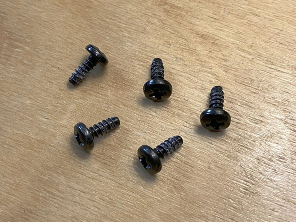 To remove the three screws that are  in wells, you may need to lift the device and tip it over. Be careful not to lose the screws as they fall out.