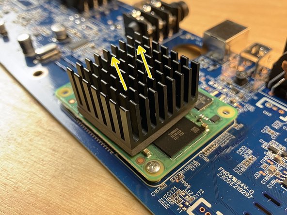 The heatsink is adhered to the chip with a gray thermal pad. This pad isn't especially sticky and it has a consistency a little bit like soft clay.