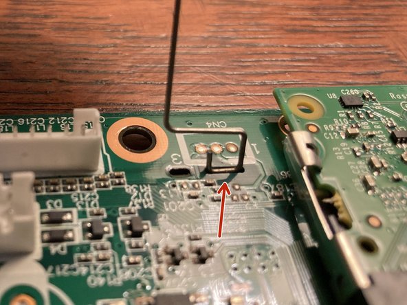 The other end of the clip (highlighted here in red) has an extra bend which helps secure it. This end can only be removed after the other end has already been released.