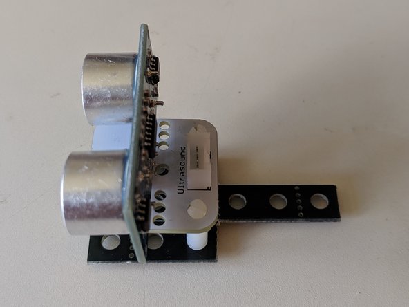 Mount your ultrasonic sensor to the platform, aligning the three legs with the holes in the platform.