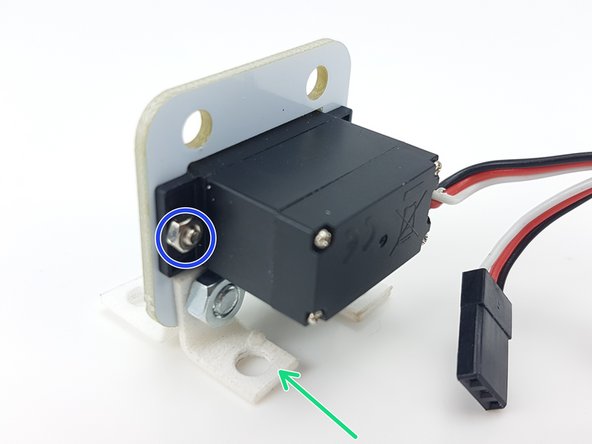 Using the two small nuts and bolts, carefully attach the servo to the PCB like in the pictures.
