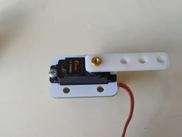 Slide the plastic beam from your servo back onto the gold cog on the servo.