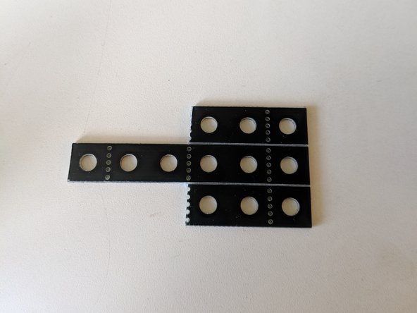 Using your construction kit and a pair of side-cutters, cut the following shape out of your beams. This will serve as the platform for the ultrasonic sensor.