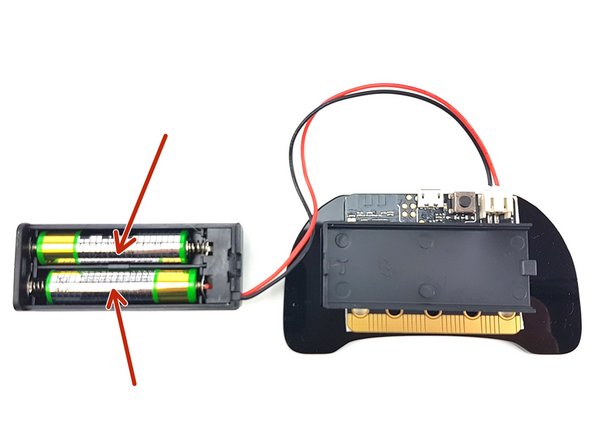Slide the cover off of the battery pack and insert the two batteries.