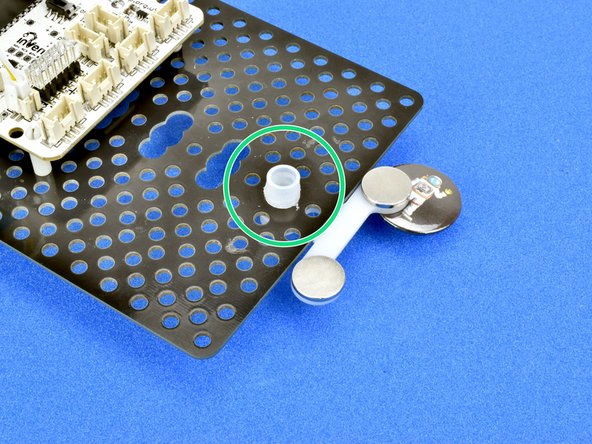 Slot the magnet module over the top of the trackball, with the magnets facing upwards like in the picture.