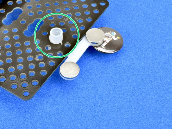 Slot the magnet module over the top of the trackball, with the magnets facing upwards like in the picture.