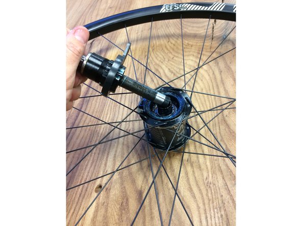 Remove the non-drive side endcap and slide the axle into the hub