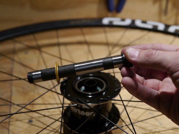 Next, slide the freehub spacer onto the axle.