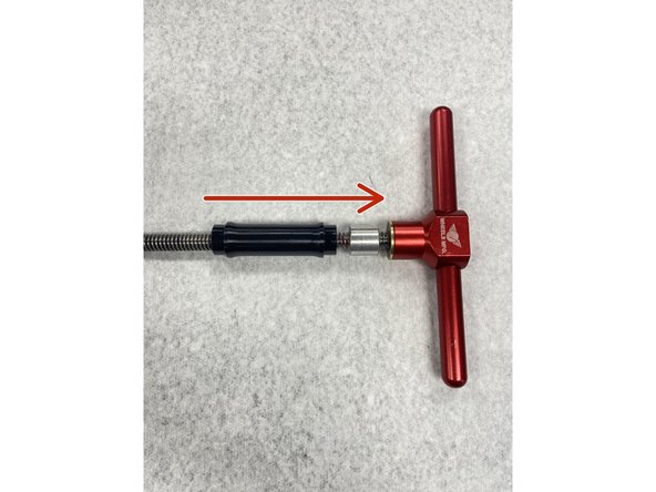 Slide the bearing removal drift and axle reducer onto the bearing press tool.