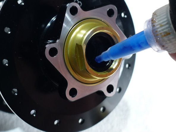 Put two drops of medium strength threadlocker on the inner axle threads