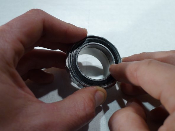 Replace the cartridge bearing seal by pressing it back into place by hand