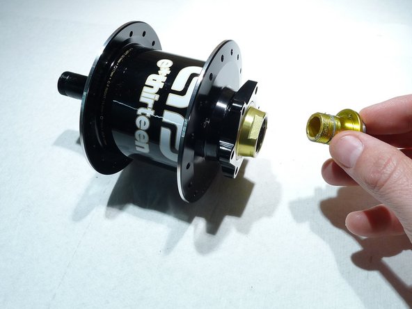 Loosen the preload ring by turning it clockwise