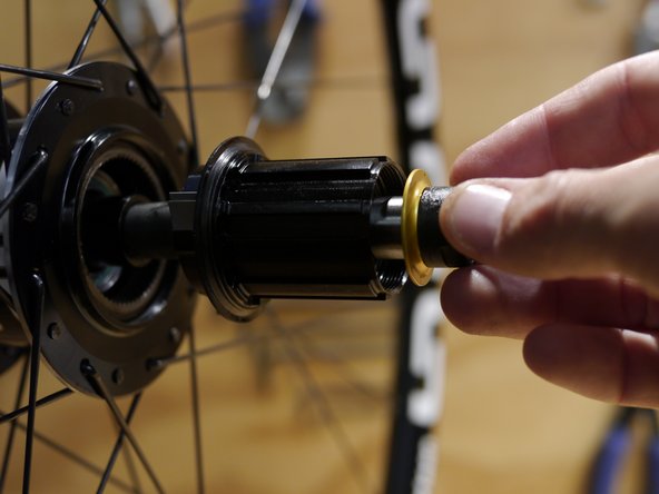 Slide the axle assembly into the freehub spacer and hub shell