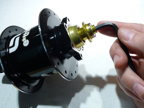 Tighten the preload adjuster by hand