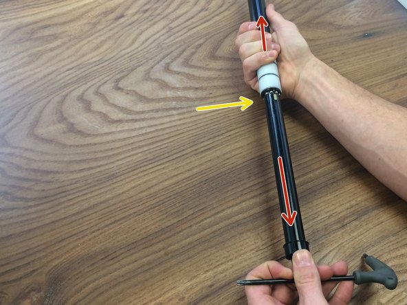 While pulling the cable tower down to release the locking mechanism, carefully slide the pillar out of the inner tube