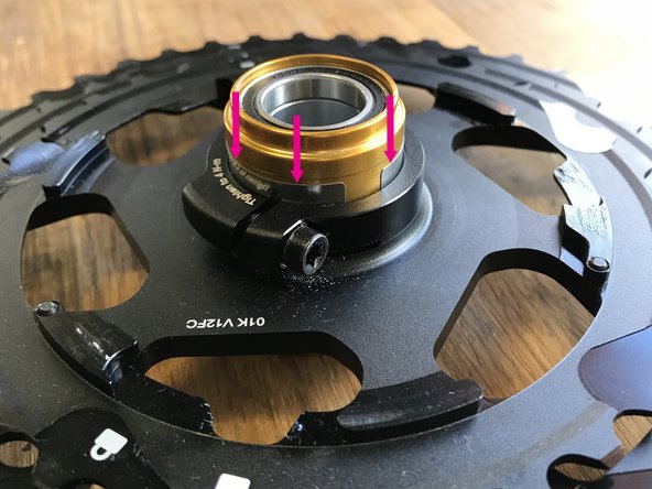 With the clamp screw completely loosened, slide the shim over the driver body and insert one shim edge in between the alloy cassette and the driver body. Then slowly work around the body pushing the shim into place until it is fully seated.