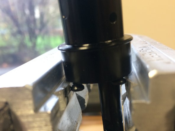 Using the 4 screws at the bottom of the pillar as flats, gently clamp them in your vise
