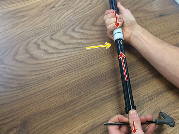 Once the balls are inside the inner tube, release the cable tower and continue sliding the pillar into the inner tube until you hear  them click into the first position