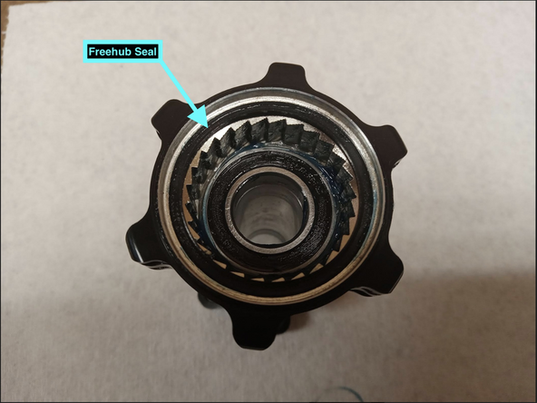 In many cases removing the freehub seal is not necessary and the seal can be simply cleaned by wiping off old grease/debris with a clean rag.