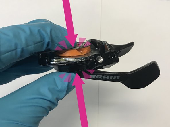 While holding the shifter body and assembly together with one hand, remove the three 2.5mm hex screws from the underside of the shifter. Set aside within easy reach.