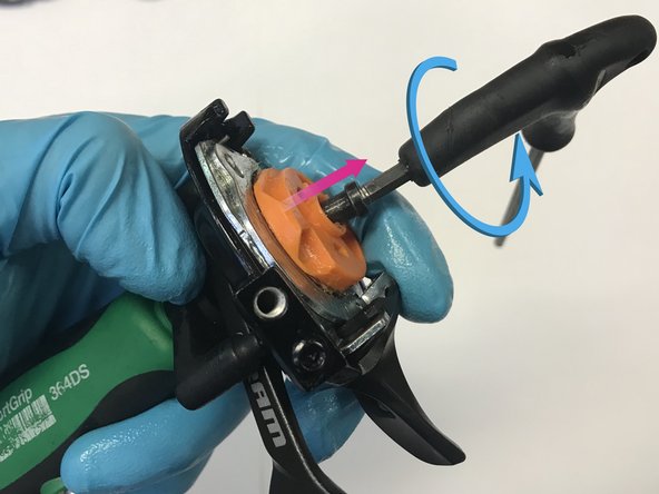 Hold the shifter/claw assembly and T25 tool stationary in your hand, then turn the 4mm hex counterclockwise to extract the spool and ratchet from the shifter. Remove the 4mm screw with the 11s spool assembly and set aside.