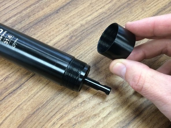 Lightly grease the threads and install the bottom cap