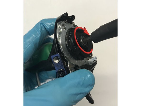 Install the spool sssembly onto the shifter. Locate the spool as shown when you press it down onto the shifter. You should be able to see the lever pawl through the small window in the spool.