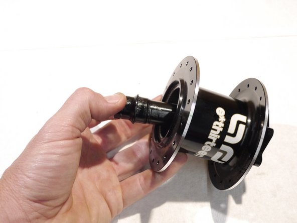 Lightly grease and slide the bearing spacer back between the bearings from the drive side