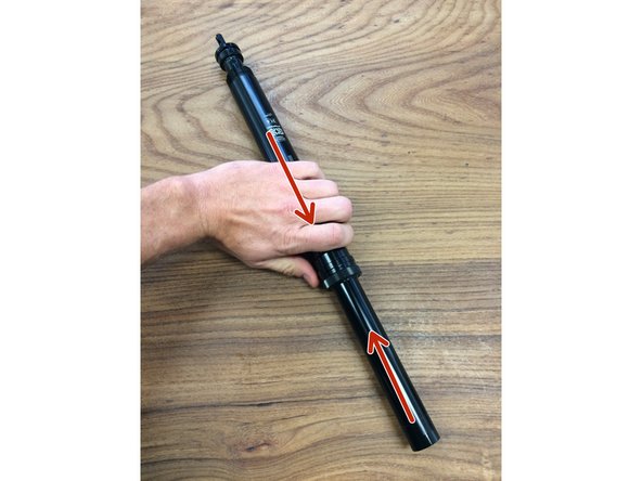 Slide the outer tube up to remove it from the post