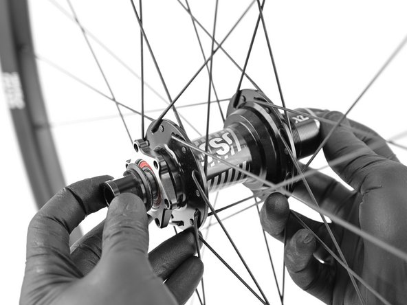 Apply a small drop of medium strength thread locker such as Loctite 243 to the axle threads.