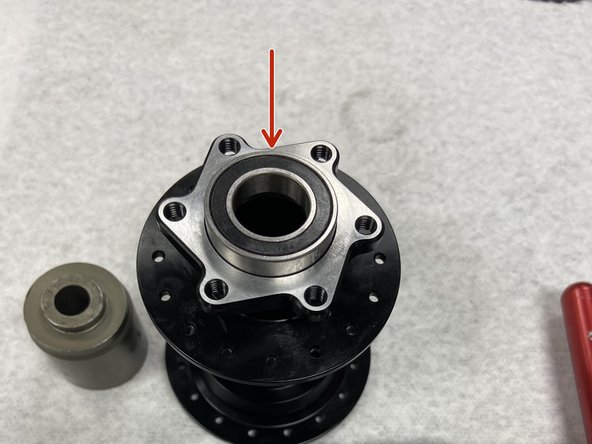 Before installing new bearings, thoroughly clean bearing bores on the hub shell. You can also add a small amount of Loctite to the clean bore before pressing the bearing in, as an optional safeguard.
