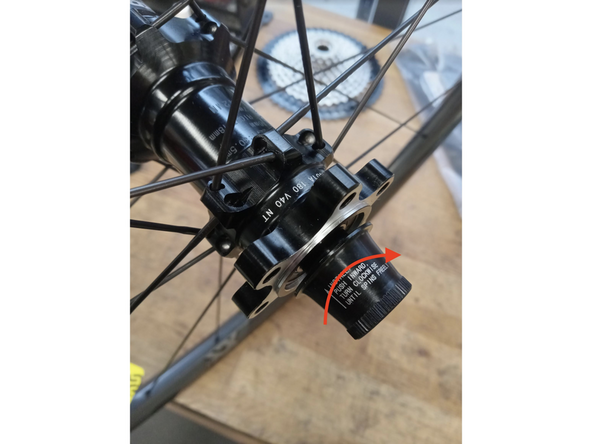 Gently apply pressure to the freehub and rotate counter clockwise. This will engage the pawls and seat the freehub in the hub shell.