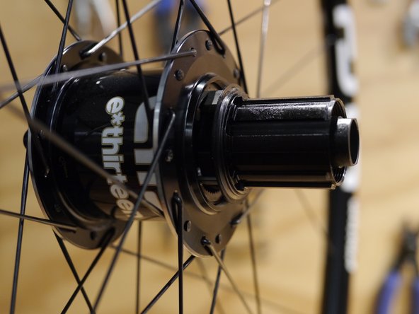 Turn the freehub body counter-clockwise to compress the pawls into the ratchet ring in the hub shell