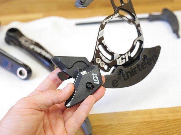 Pull the bolt out slightly and rotate the lower slider open