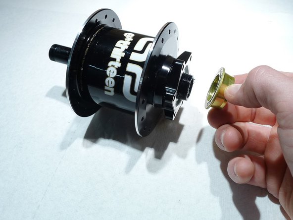 Loosen the preload ring by turning it clockwise