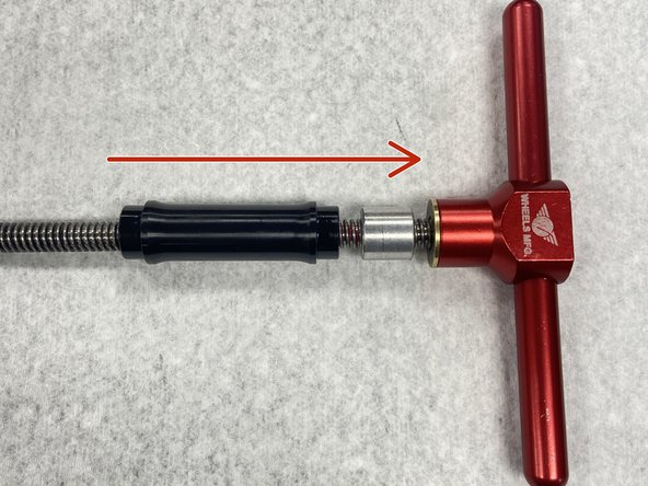 Slide the bearing removal drift and axle reducer onto the bearing press tool.