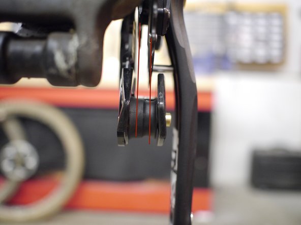 Sight down the back of the bike and check the chainrings to make sure they are properly aligned with the lower roller
