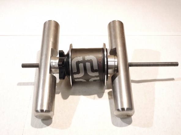 Tighten the tool handles to press the bearings in