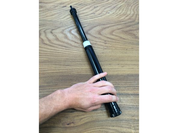 Slide the outer tube up to remove it from the post