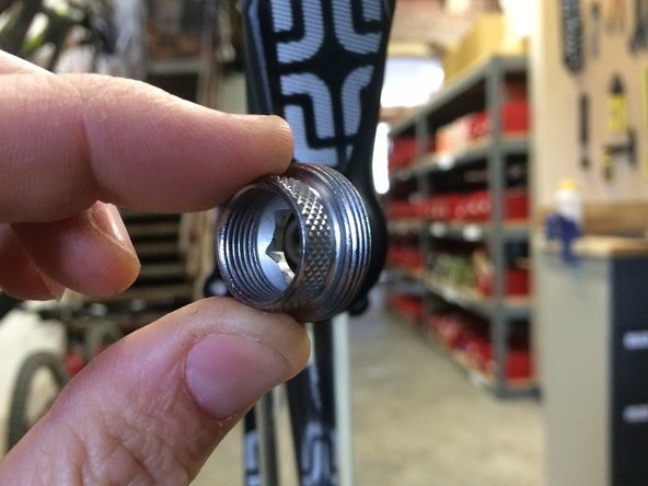 Lightly grease the threads and face of the extractor plate tool and install it into the crank arm