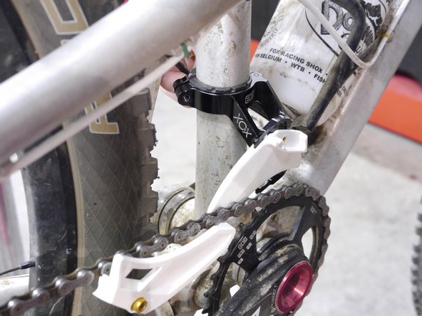 clamp the guide over the shim cam and lightly tighten the fixing bolt