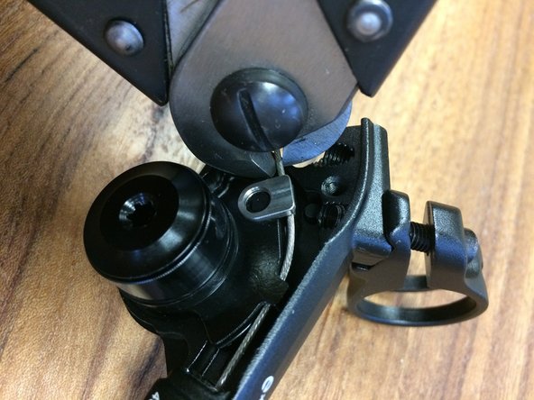 You can trim it close to the clamp or bend it down slightly and install a cable end close to the clamp (we removed the lever for a better view)